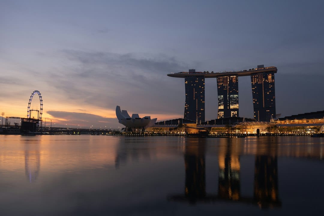 Wide dusk view of a luxury Singapore landed home, full-bleed editorial architectural photograph